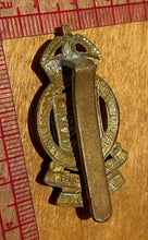 Load image into Gallery viewer, WW2 British Army ROYAL ARMY ORDNANCE CORPS Cap badge in white metal & brass - The Militaria Shop
