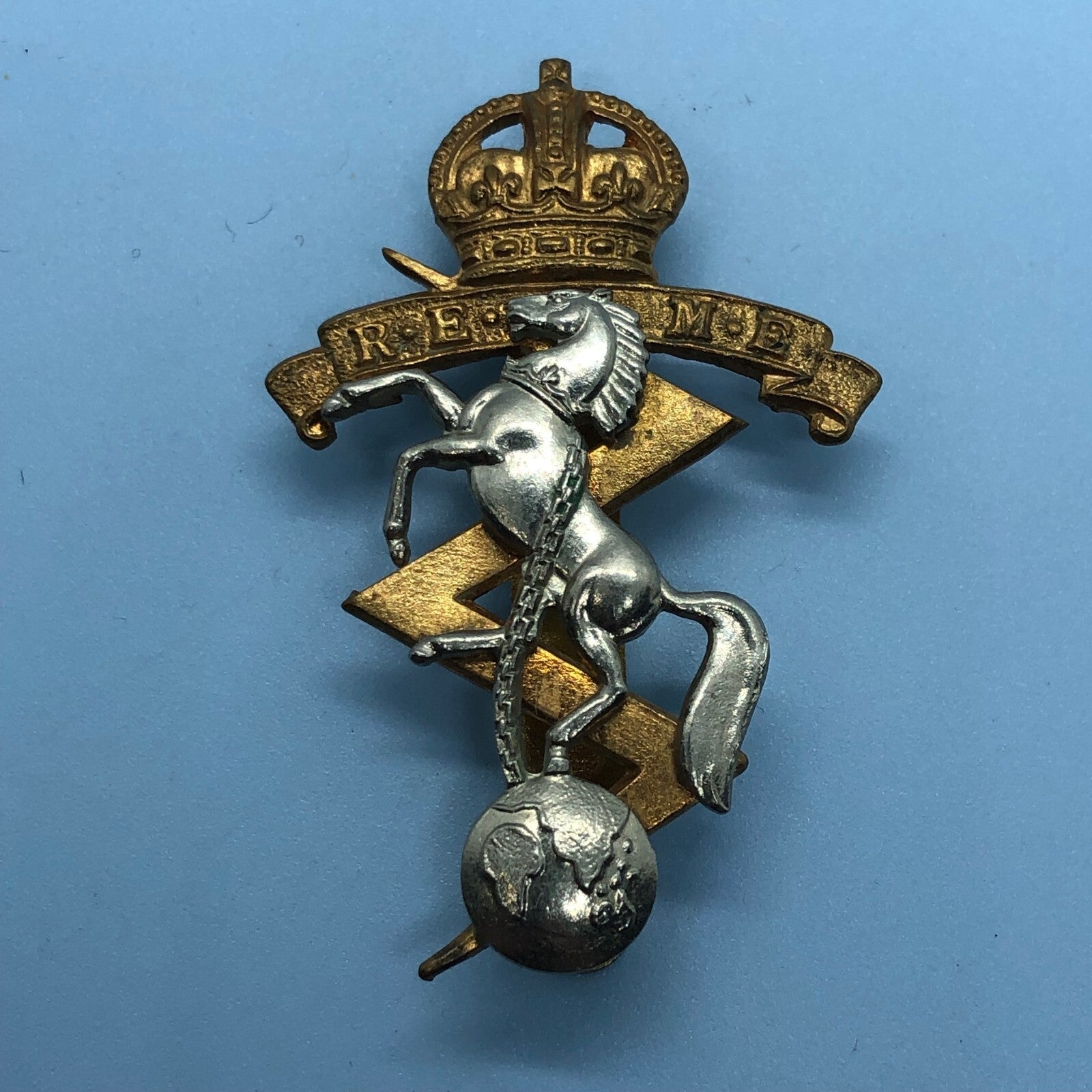 Genuine British Army Cap Badge - Royal Electrical and Mechanical Engineers - The Militaria Shop