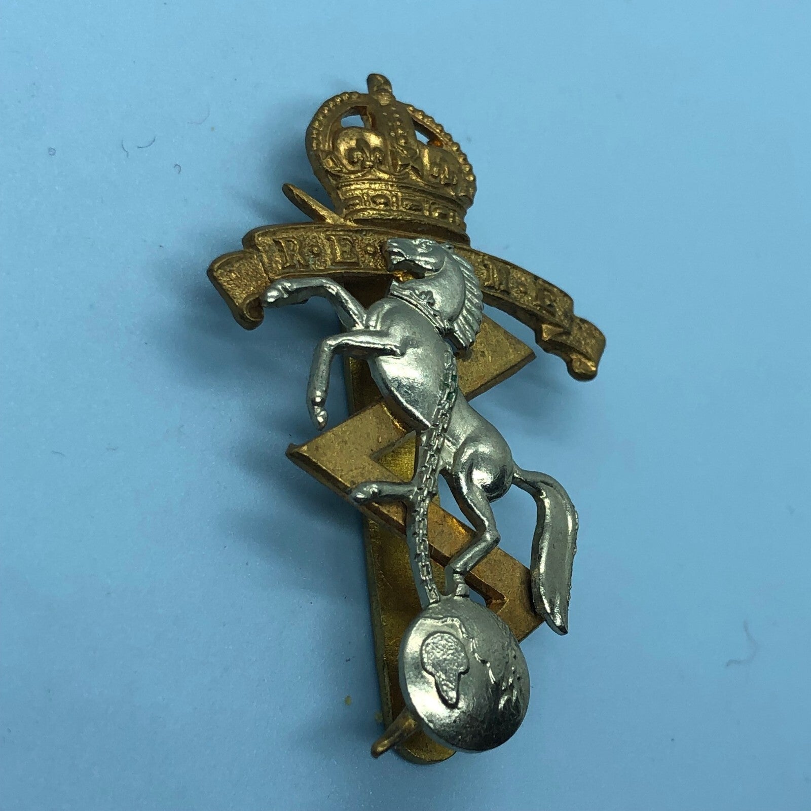 Genuine British Army Cap Badge - Royal Electrical and Mechanical Engineers - The Militaria Shop