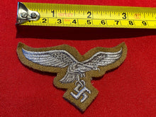 Load image into Gallery viewer, Reproduction Luftwaffe Tropical Breast Eagle badge on a tan background. - The Militaria Shop