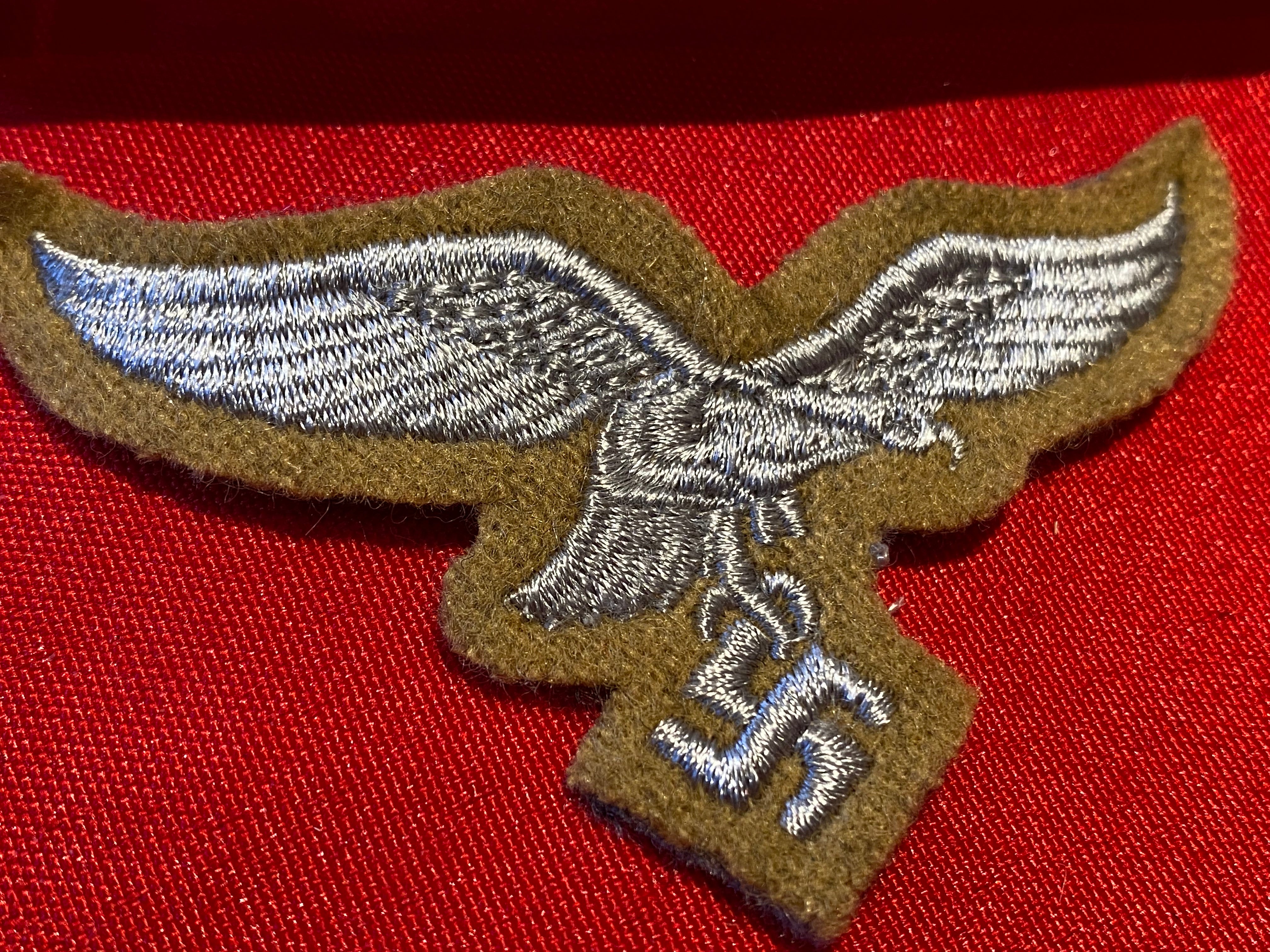 Reproduction Luftwaffe Tropical Breast Eagle badge on a tan background. - The Militaria Shop