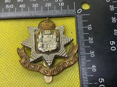 British Army East Surrey Regiment Cap Badge. Kings Crown - The Militaria Shop