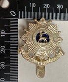 A white metal British Army Bedfordshire & Hertfordshire Regiment cap badge. - The Militaria Shop