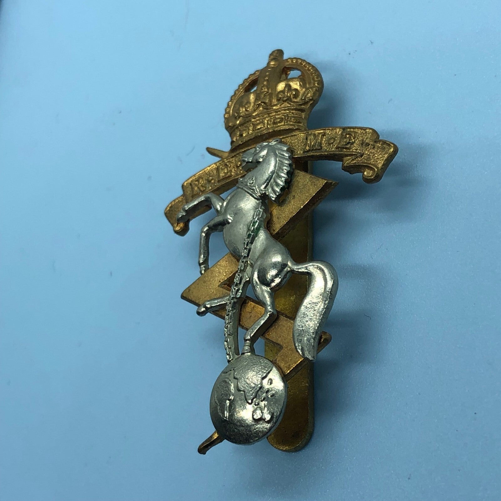 Genuine British Army Cap Badge - Royal Electrical and Mechanical Engineers - The Militaria Shop