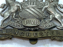 Load image into Gallery viewer, Original British Army WW1 1st Volunteer Battalion Manchester Regiment Cap Badge
