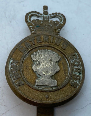 A worn Queens crown ARMY CATERING CORPS cap badge with rear slider -- -- B36 - The Militaria Shop