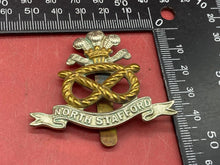 Load image into Gallery viewer, WW1 / WW2 British Army - NORTH STAFFORDSHIRE - White Metal and Brass Cap Badge.
