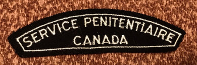 A vintage CANADA SERVICE PENITENTIAIRE cloth shoulder title.                B4 - The Militaria Shop