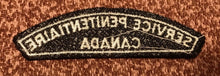 Load image into Gallery viewer, A vintage CANADA SERVICE PENITENTIAIRE cloth shoulder title.                B4
