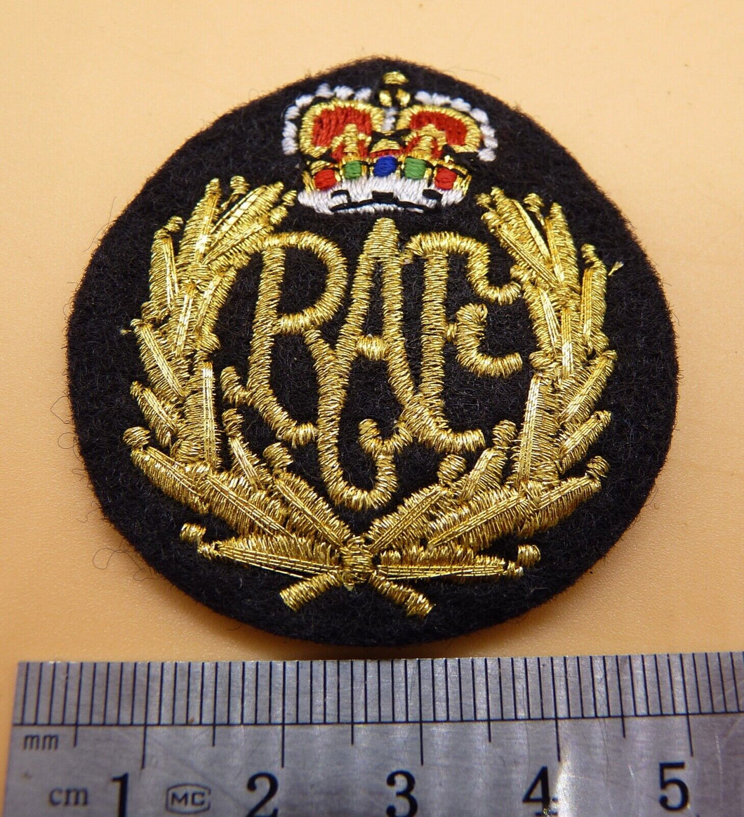 RAF QC - Royal Air Force current issue padded cap badge. Brand new and unissued.
