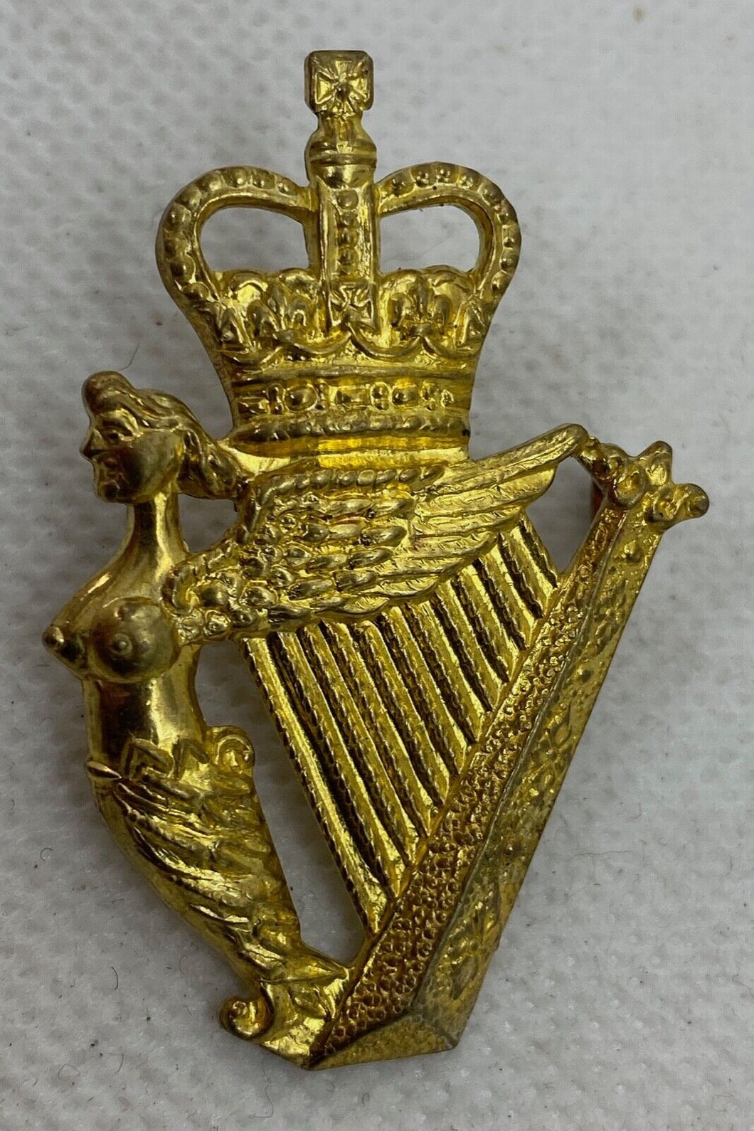 A lovely condition Queens Crown gilt metal Royal Irish Regiment cap badge  B62