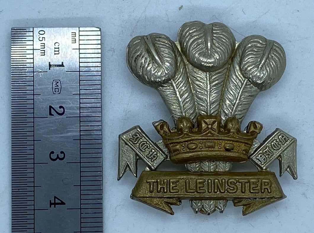 THE LEINSTER Regiment cap badge in brass & white metal with rear slider - - B36
