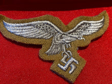 Load image into Gallery viewer, Reproduction Luftwaffe Tropical Breast Eagle badge on a tan background.
