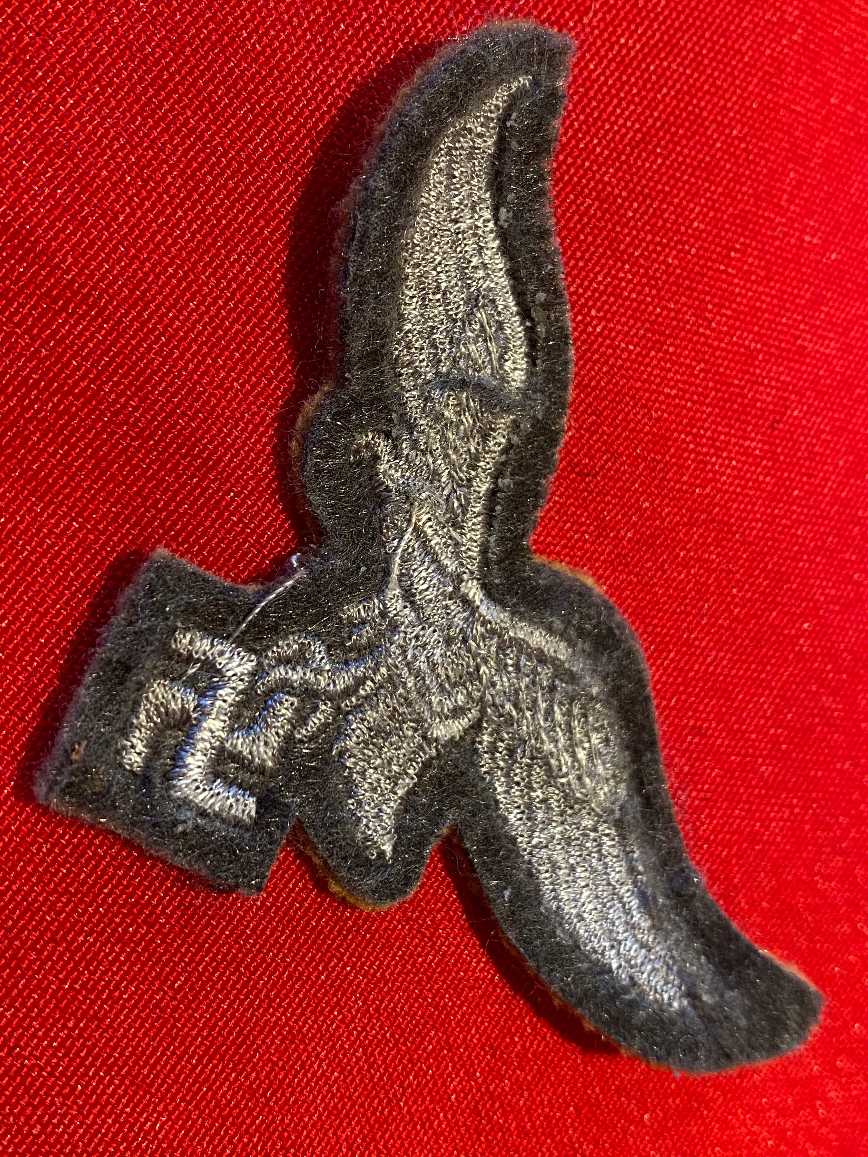 Reproduction Luftwaffe Tropical Breast Eagle badge on a tan background. - The Militaria Shop